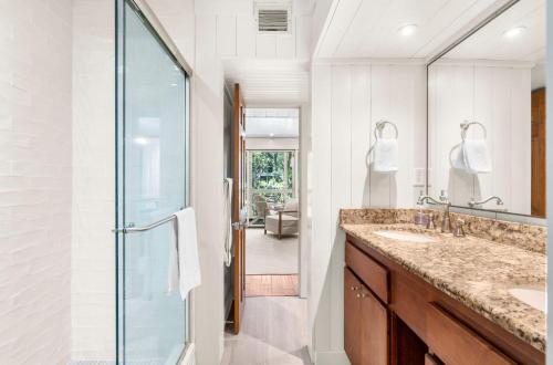 a bathroom with two sinks and a glass shower at 3584 Shipwatch Rd in Kiawah Island
