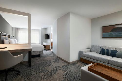 a hotel room with a bed and a desk at SpringHill Suites Dallas Arlington North in Arlington