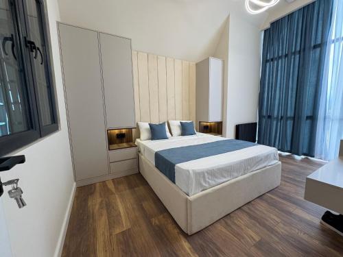 a bedroom with a large bed with blue pillows at Arinest Villa with heated pool, 20 min from Yerevan in Elar