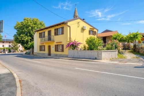 a yellow house on the side of a road at Vila Leonarda with Terrace and Garden - Happy Rentals in Miren
