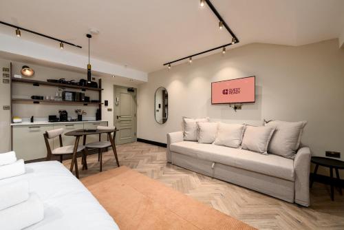 a living room with a couch and a table at GuestReady - The Euston in London