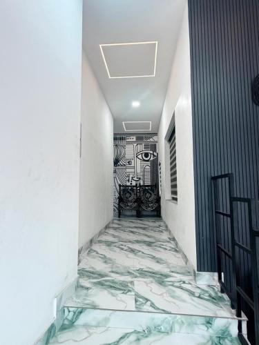 a hallway with a marble floor in a building at Padmora in Trivandrum