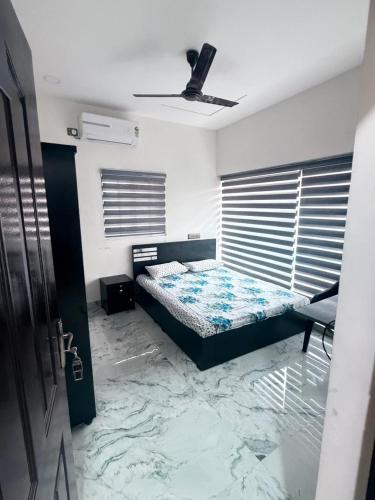 a bedroom with a bed in a room with marble floors at Padmora in Trivandrum