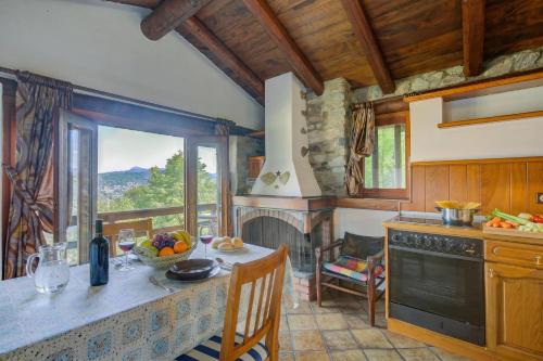 a kitchen with a table and a fireplace at La Capannina Lake & Mountain Views - Happy Rentals in Cimo