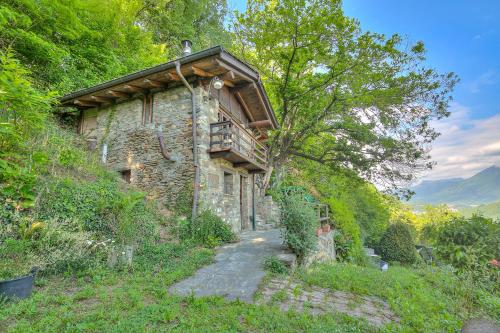 a stone house with a balcony on a hill at La Capannina Lake & Mountain Views - Happy Rentals in Cimo