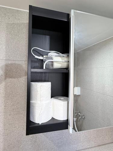 a cabinet with a bunch of rolls of toilet paper at 303 Stayonyou Gocheok Dome Hongdae Subway 3Min in Gwangmyeong
