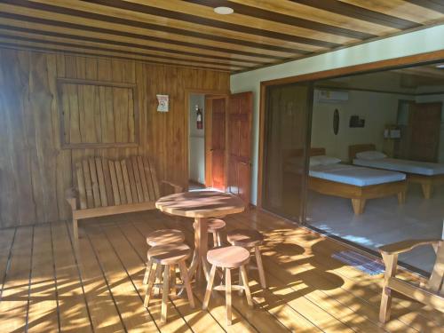 a room with two stools and a table and a bed at Drake Bay Corcovado The Monkey Trail in Drake
