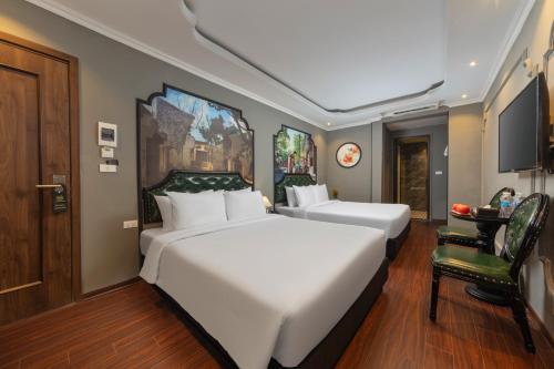 a hotel room with two beds and a chair at Madelise Ensora Hotel & Travel in Hanoi