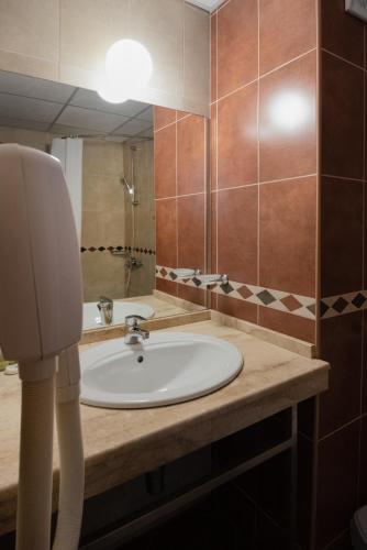 a bathroom with a sink and a mirror at Hotel Nadia in Primorsko