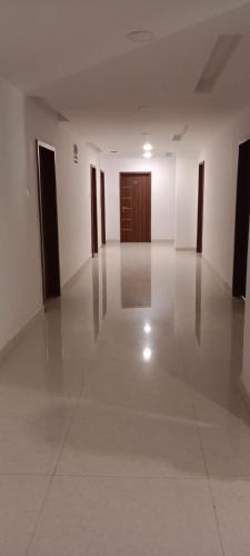 an empty room with white walls and a wooden door at Sri Krishna Residency in Tirupati
