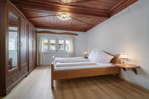 a bedroom with a bed and a wooden ceiling at Haus Anna in Kirchberg in Tirol