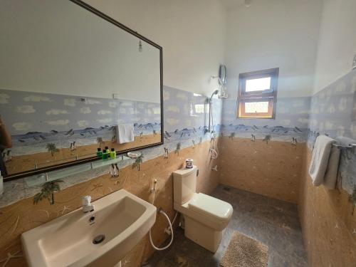 a bathroom with a sink and a toilet at Polo Region Rest Inn in Haputale
