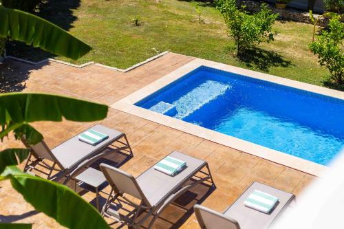 an overhead view of a patio with chairs and a pool at Sa Font in Puigpunyent