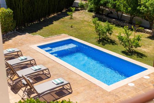 an overhead view of a swimming pool with lounge chairs at Sa Font in Puigpunyent