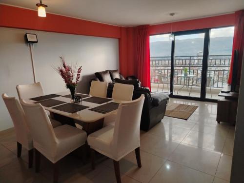 a dining room with a table and a couch at Alojamiento Wanka in Huancayo