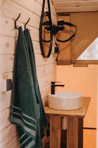 a bathroom with a sink and a green towel at Kwiejcówka in Kwiejce
