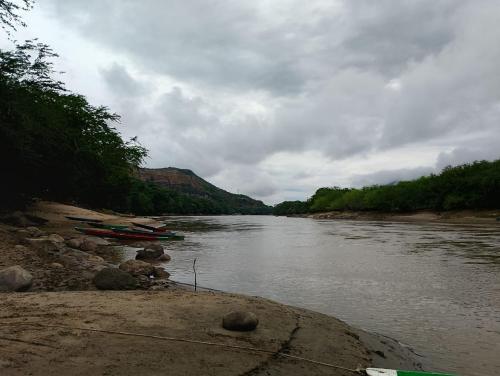 a river with two boats on the side of it at EcoHonda Low Cost in Honda