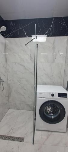 a washing machine in a shower in a bathroom at Infinity Studio, Shkorpilovtsi in Shkorpilovtsi