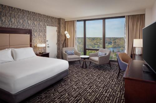 a hotel room with a bed and a desk and chairs at DoubleTree by Hilton Cherry Hill Philadelphia in Cherry Hill