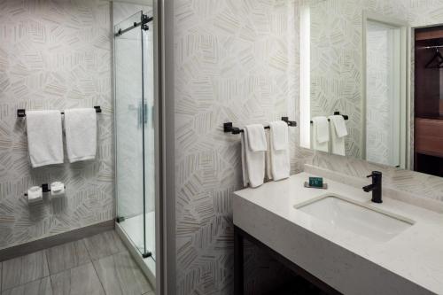 a bathroom with a sink and a shower at DoubleTree by Hilton Cherry Hill Philadelphia in Cherry Hill