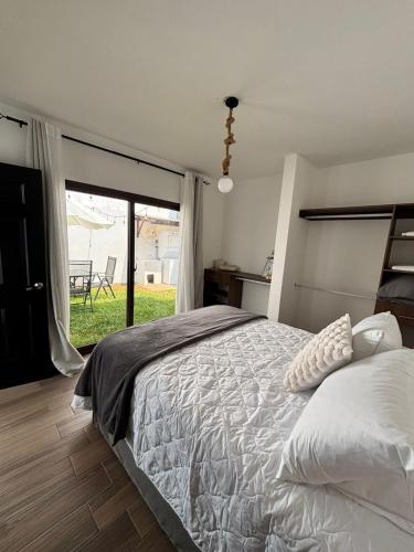 a bedroom with a large bed and a large window at Casa Mura in San Lorenzo El Cubo