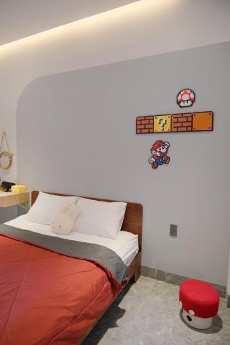a bedroom with a bed and a red stool at Thỏ Chill Homestay in Vung Tau