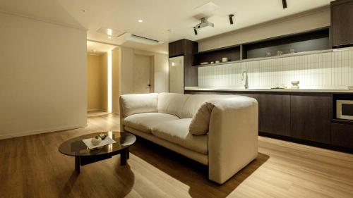 a living room with a couch and a table at Anook Stay Daejeon Daeheung in Daejeon