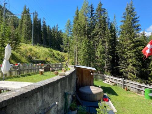 a toilet sitting on a wall in a yard at Carolina Gatekeeper's House in Zernez