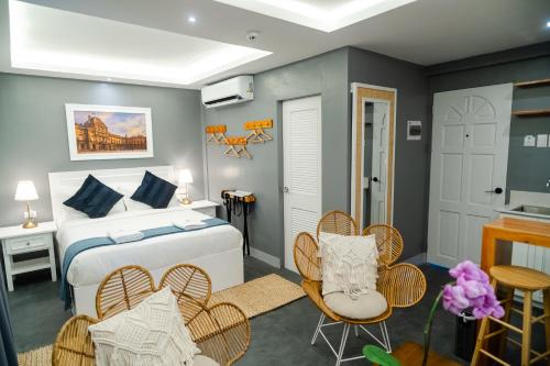 a bedroom with a bed and a table and chairs at Hotel Bijoux in Plaridel