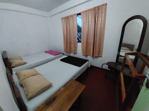 a bedroom with two bunk beds and a mirror at Sanara Hotel in Nuwara Eliya