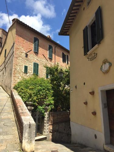 an old brick building with a gate in a street at La Locanda Di San Francesco in Montepulciano