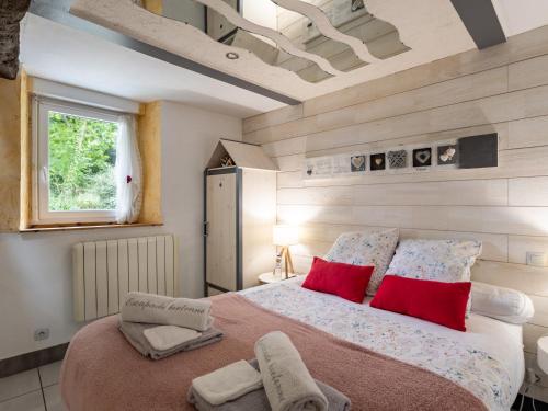 a bedroom with a large bed with red pillows at Escapade Bretonne in Lannion