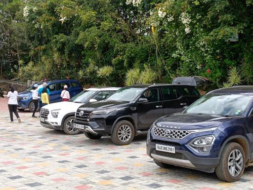 a group of cars parked in a parking lot at Bougainvillea in Chikmagalūr