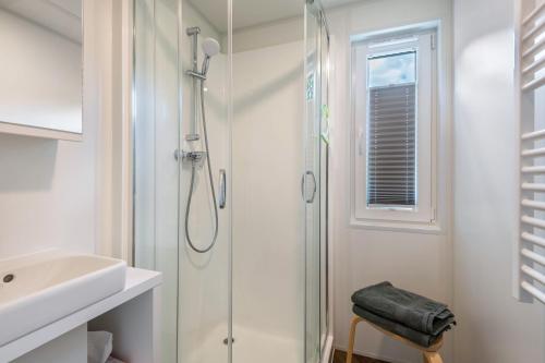 a bathroom with a shower and a sink at Holiday Home Tiny Haus Sunside in Riedenburg