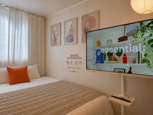 a bedroom with a bed and a flat screen tv at 스테이 온기 in Suwon