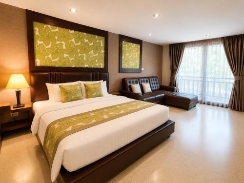 a large bedroom with a large bed and a couch at Aranta Suvarnabhumi in Lat Krabang