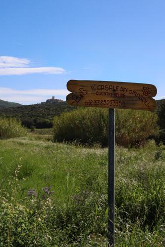 a sign in the middle of a field at "IL CASALE DEI GIRASOLI" Country House in Capalbio in Capalbio