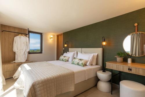 a bedroom with a large bed and a mirror at Ark Luxury Suite, Hot tub & Sea Views, by ZanteWize in Tragaki