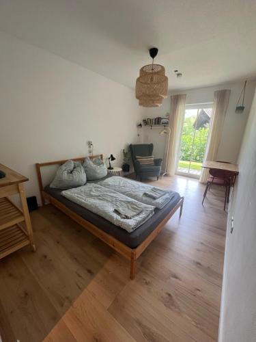 a bedroom with a bed and a chair in it at Schöne Wohnung in Passau in Passau