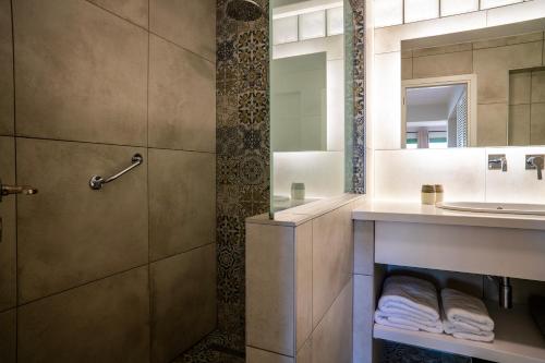 a bathroom with a sink and a shower at Liostasi Country Houses in Palekastron