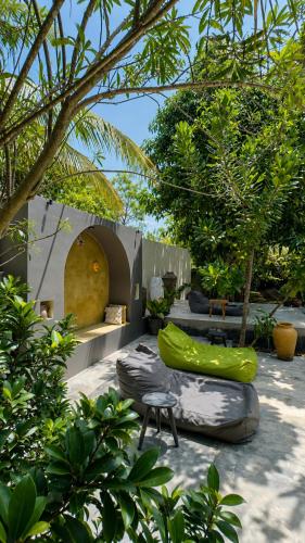 a garden with some chairs and trees at Richards Cabanas in Tissamaharama