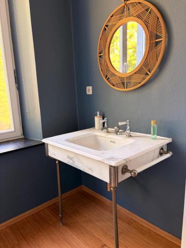 a bathroom with a white sink and a mirror at Le Palais d'Orient - Suite avec salle d'eau in Hannut