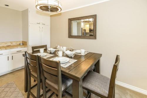 a dining room with a wooden table and chairs at B205 - Ocean Escape in Oceanside