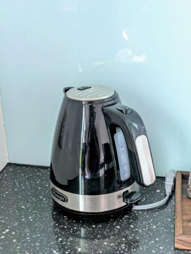 a tea kettle is sitting on a kitchen counter at Kamuy Chalet Hakuba by Jade Villa in Hakuba