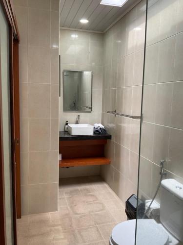 a bathroom with a sink and a mirror at Sariuma babadan in Badung