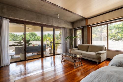 a living room with a couch and a table at Alumina アルミナ in Kin