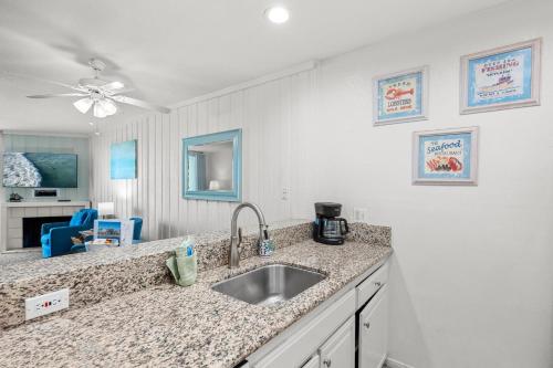 a kitchen with a sink and a counter top at A304 - Sail Away Stay in Oceanside