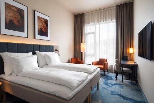 a hotel room with a bed and a window at Thon Hotel Drammen in Drammen