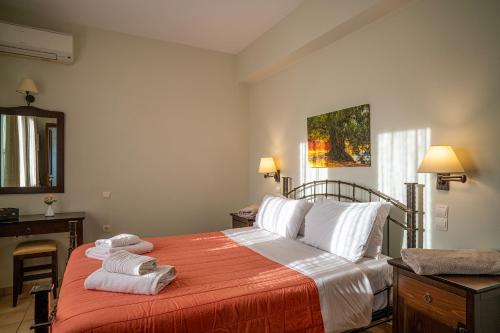a bedroom with a bed with towels on it at Liostasi Country Houses in Palekastron