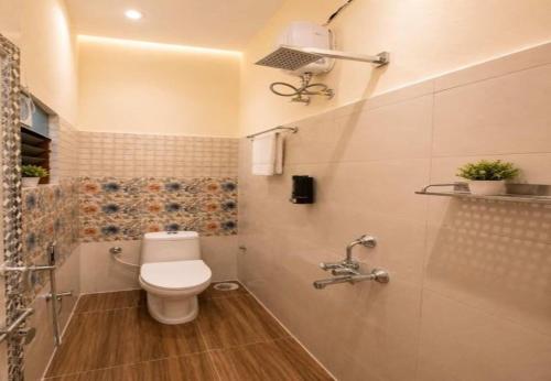 a bathroom with a toilet and a shower at Dev'S Inn Luxurious Homestays in Similigurha